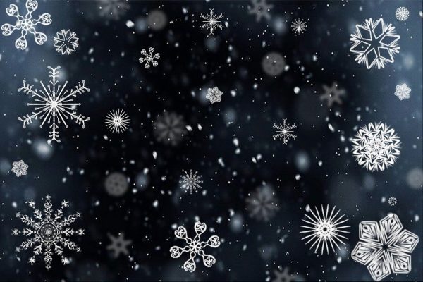Snowflakes on a black background to represent the Winter Aromatherapy Collection.