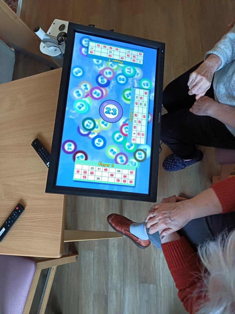 The Serene being used for a game of bingo with two ladies in a care home