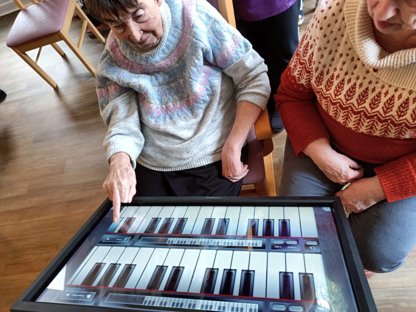 The Serene mobile interactive screen being used in a table position for care home activity time